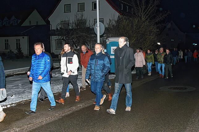 Nachdem klar ist, dass der Saal im Gemeindehaus zu klein ist, zieht eine lange Karavane an interessierten Zuhörern in die Sporthalle um.