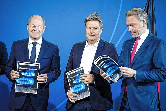 Bundeskanzler Olaf Scholz (von links), Bundeswirtschaftsminister Robert Habeck und Bundesfinanzminister Christian Lindner mit dem ...