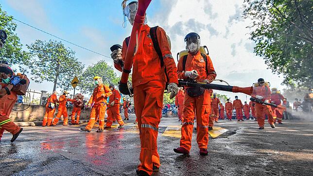 In Kuala Lumpur desinfizieren Stadtarbeiter die Straße, um die Verbreitung des Coronavirus einzudämmen. Auch die Nachbarn der ...