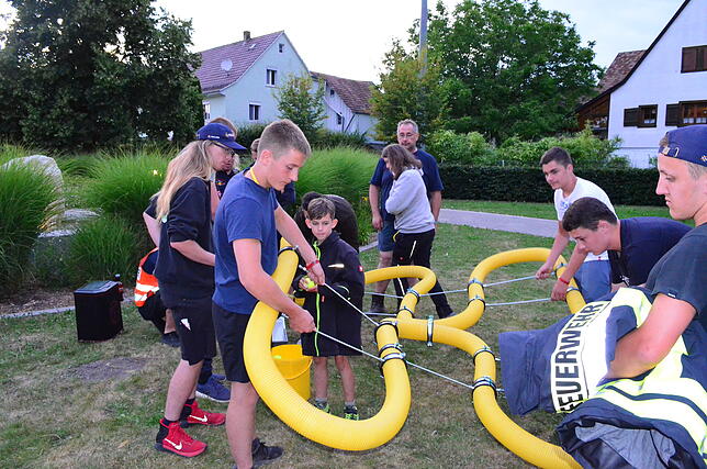 Jugendfeuerwehr-Mitglieder bei einer der praktischen Aufgaben zu Beginn der Nachtwanderung. Bild: Susanne Schön