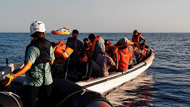 Während der ersten Rettungsmission im Mittelmeer rettet die Besatzung des Motorschiffes Sarah – im Hintergrund zu sehen – unter dem ...