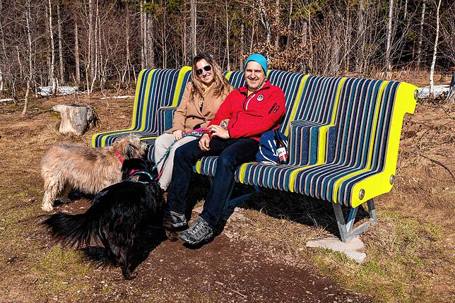 Nicole Richter und Stephan Koch genießen mit ihren Hunden Finnchen und Lilo den Ausblick von der überdimensionierten Sitzbank am Fuße ...