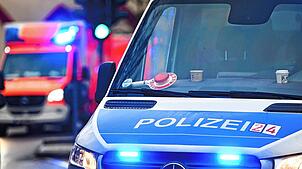 Ein Polizeiauto und ein Rettungswagen mit Blaulicht.