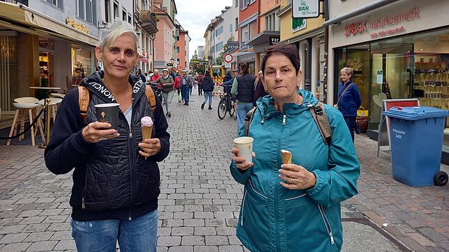 Marion Sehr (links) und Astrid Brill aus dem Saarland genießen ihr Eis in der Konstanzer Fußgängerzone und einen Kaffee zum Mitnehmen ...