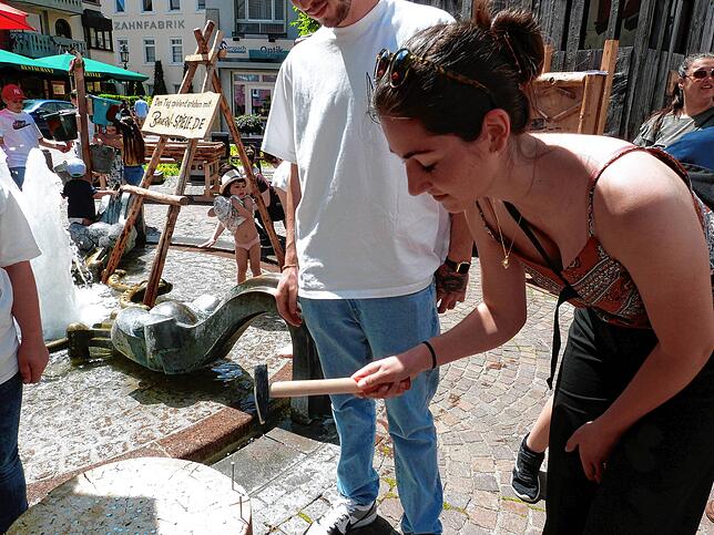 Ganz schön schwierig findet es Fabienne Sciangola einen dicken langen Nagel mit der Schmalen Seite eines Hammers in einen Holzblock zu ...