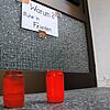Am Eingang zum Haus der Getöteten stehen kurz nach der Tat Grabkerzen. An der Tür hängt ein Schild mit der Aufschrift: &bdquo;Warum? ...