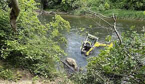 Der Bagger ist abgerutscht und wird vom Wasser der Birs bei Aesch (Kanton Basel-Landschaft) umspült.