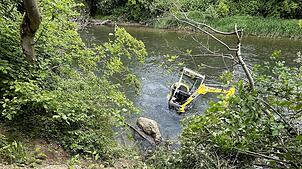Der Bagger ist abgerutscht und wird vom Wasser der Birs bei Aesch (Kanton Basel-Landschaft) umspült.
