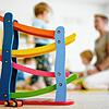 Eine Erzieherin spielt in einer Kindertagesstätte in Schriesheim am 29.06.2020 hinter einer Rollbahn mit Kindern.