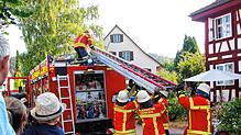 Nach dem erfolgreichen Übungseinsatz im Landgasthof Engel vor gespanntem Publikum wird die Schiebeleiter wieder auf dem Feuerwehrauto ...