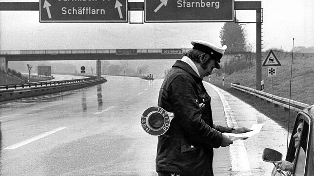 Ein Autofahrer muss am 25. November 1973, am ersten autofreien Sonntag, auf der Autobahn München-Garmisch seine Sonderfahrerlaubnis ...