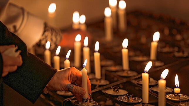 Nach dem Tod von Papst Franziskus zünden Trauernde nach einem Gottesdienst in der Stuttgarter Domkirche St. Eberhard Kerzen an.