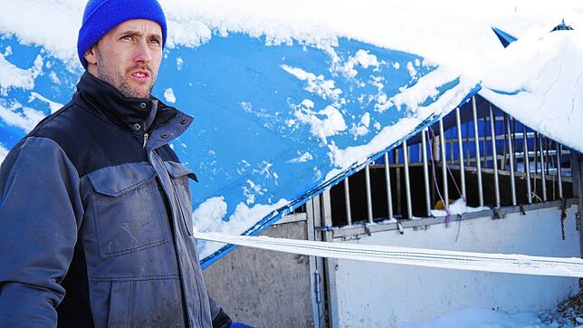 Dustin Renz steht in der Mitte des eingestürzten Zeltes. Über ihm sollte normal das Zeltdach sein, doch hier ragt nach dem Winterunglück ...