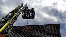 Die Feuerwehrleute setzen die Drehleiter ein. Im Korb sind sie aber nicht allein.