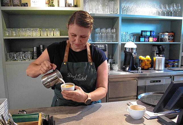 Claudia Seifert zeigt, wie man die Milch richtig eingießt, damit auf dem Cappuccino ein schönes Muster entsteht.