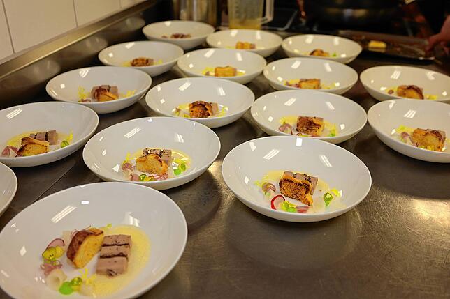 Zum Verkosten stehen hier Teller mit Gänseleberterrine mit dunkler Kuvertüre, Süßweingelee, Kohlrabicreme, eingelegtem Kohlrabi, ...