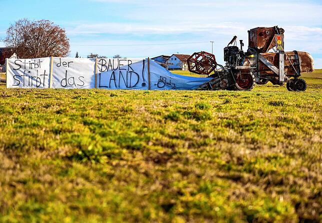 „Stirbt der Bauer, stirbt das Land“, steht auf einem Transparent in Winterlingen. Danabe steht ein alter Mähdrescher.