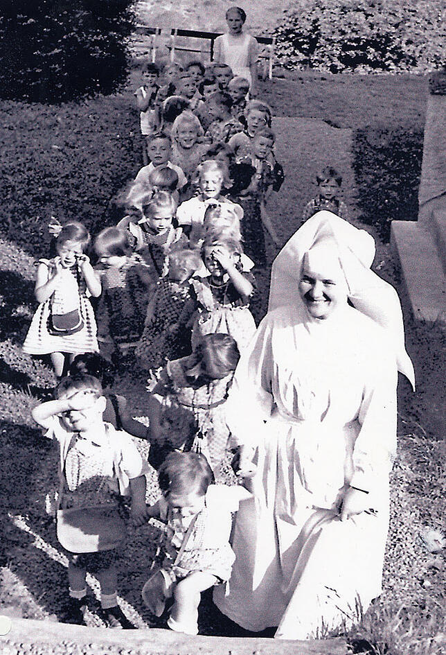 Ein Spaziergang mit vielen Kindern in der Nachkriegszeit. Im Hintergrund "Tante Cilli".
