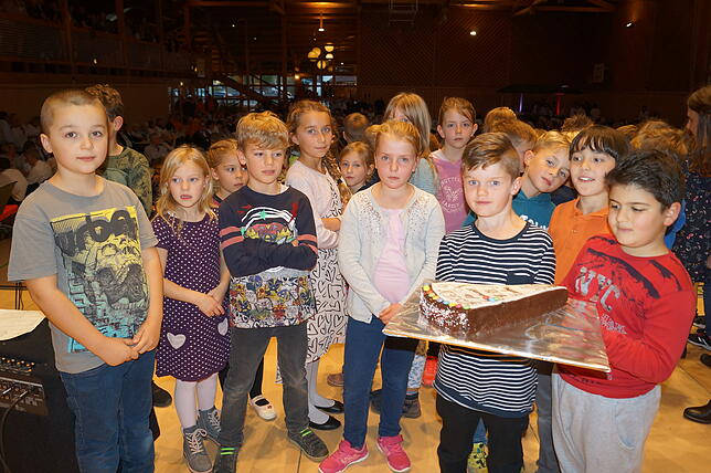 Frickinger Kids freuen sich über Kuchen als Preis für ihre Bilder zur Partnerschaft.