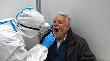 Wolfgang Döbele aus Bad Säckingen wird im Testzentrum im Kultursaal von Samira Borchers vom DRK Wehr mit einem Antigen-Schnelltest getestet.