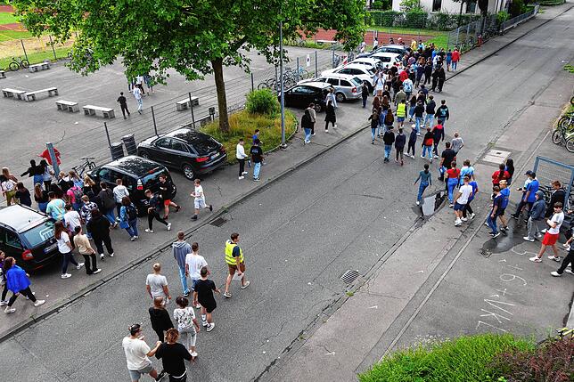 Ruhig und in kleinen Gruppen verließen die Schüler nach dem Alarm die Schule und sammelten sich auf dem gegenüberliegenden Sportplatz.