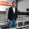 Werner Späth, Geschäftsführer der FAB Fördertechnik und Anlagenbau, steht in einem Rollenfördersystem, das FAB aktuell für einen ...