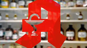 Das bekannte Logo an der Tür einer Apotheke (Symbolbild). In zahlreichen kleinen Gemeinden sind die Türen der örtlichen Apotheke ...