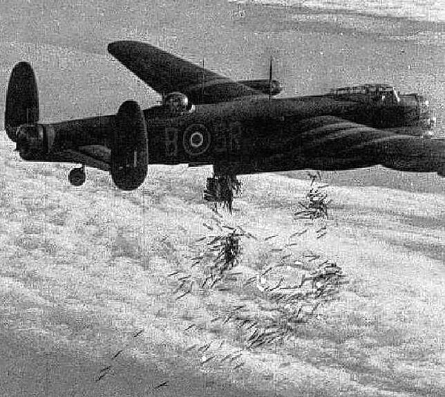 Ein viermotoriger britischer Lancaster-Bomber beim Abwurf von Brandbomben auf eine Großstadt.