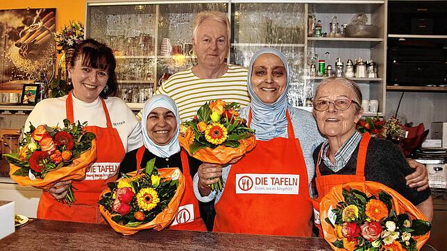 Die Singener Tafel feiert 25 Jahre Mittagstisch in Singen: Zur Feier des Tages überreichte Udo Engelhardt einen Blumenstrauß an (von ...