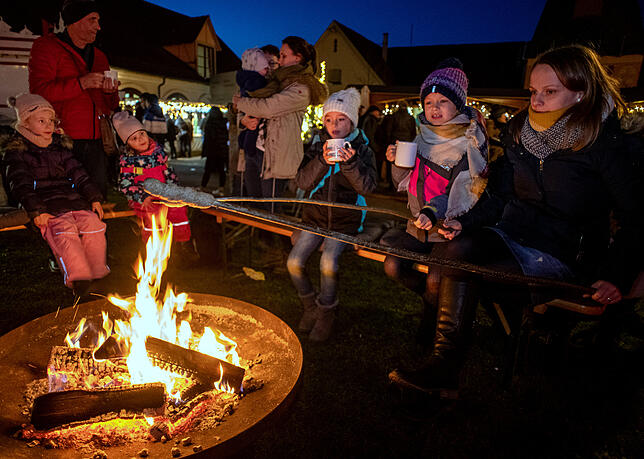 Ständig umlagert war die Feuerstelle bei der Schlossremise, wo die Kinder am wärmenden Lagerfeuer leckeres Stockbrot grillen und ...