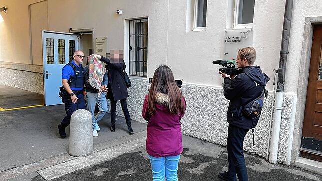 Polizisten führen den Beschuldigten aus dem Gerichtsgebäude in Frauenfeld. Seine Verteidigerin verdeckt sein Gesicht mit ihrem Schal.
