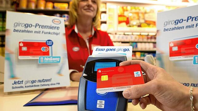 Während der Corona-Pandemie wird das als hygienischer empfunden: Ein Kunde bezahlt im Verkaufsraum einer Tankstelle mit dem sogenannten ...