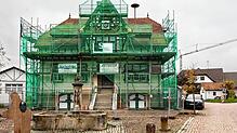 Ist derzeit komplett für die Sanierungsarbeiten eingerüstet: Das ehemalige Rathaus im Mooser Ortsteil Iznang.