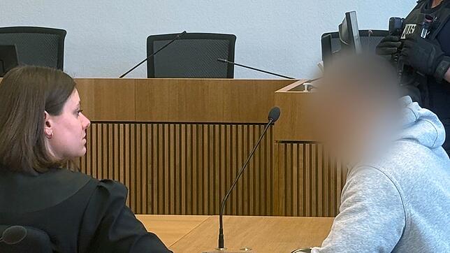 Ein mutmaßlicher Einbrecher sitzt im Stuttgarter Landgericht auf der Anklagebank und berät sich mit seiner Anwältin.