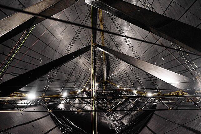Blick in die Hülle eines der Zeppeline, die gerade gewartet werden. Beim Vergleich erkennt man, dass das Längsträgerfachwerk, das für ...