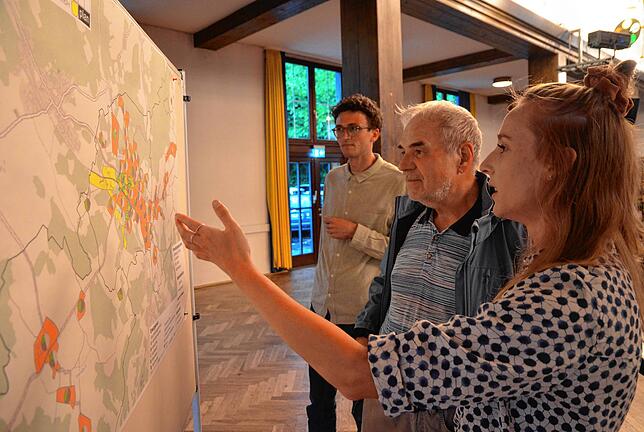 Planerin Lucy Kraus (rechts) erläutert Lothar Schauer, wo in Markdorf welche Energiegewinnung denkbar ist. Im Hintergrund steht Leon Beck.