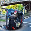 Nach der Kollision mit einer Ampel überschlägt sich ein mit drei Personen besetztes Auto und bleibt auf der Seite liegen.