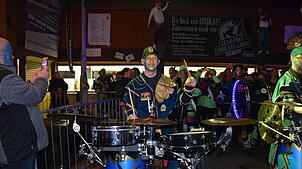 Der Mann an den Drums sorgt für die heißen Rhythmen und strahlt dabei noch in die Kamera.