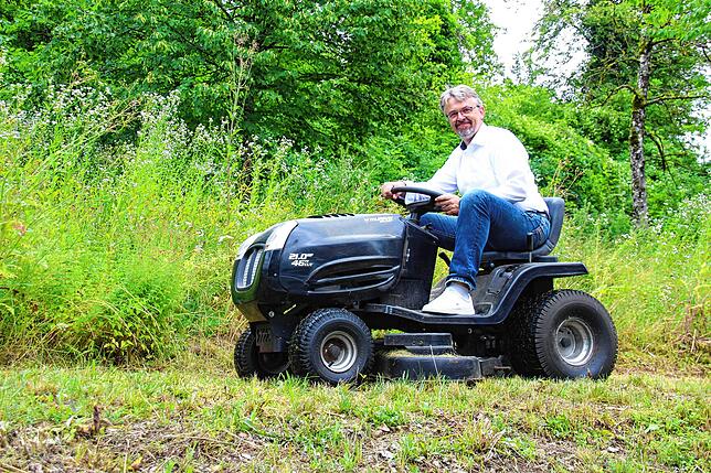 Den Rasen seines Grundstückes mäht Martin Gruner mit einem Rasenmähertraktor.