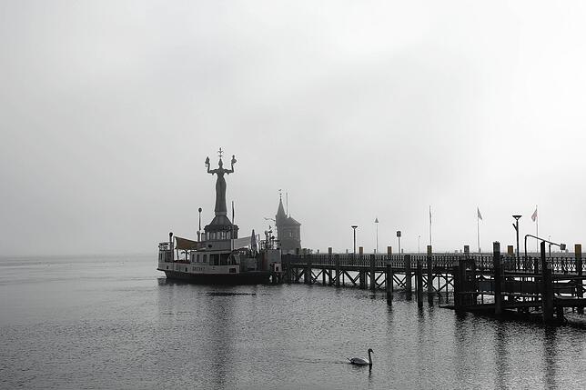 Die Imperia umringt von einer eher tristen Atmosphäre: Der Hafenturm im Hintergrund ist bei dieser Wetterlage nur mühsam auszumachen.