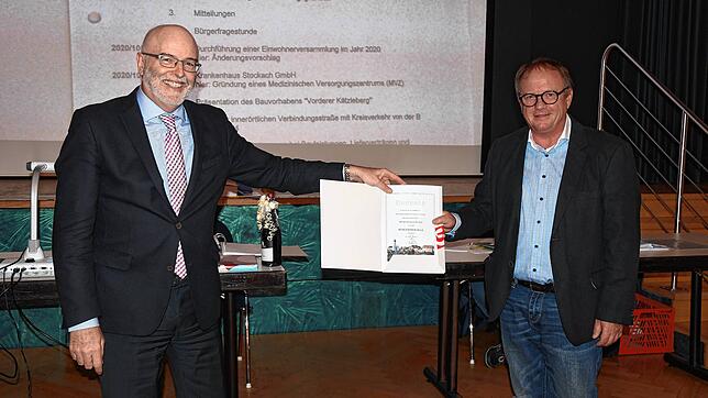 Urkundenübergabe mit Corona-Sicherheitsabstand: Stockachs Bürgermeister Rainer Stolz (links) verleiht Harald Karge die Bürgermedaille.