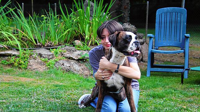 Janis Brachat schmust mit dem Familienhund LaToya. Der Kontakt zu dem Boxer ist für die Autistin einfacher als zu den meisten Menschen.