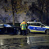 Beamte untersuchen in der Fürstenrieder Straße in München das Auto des Rasers (links).