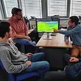 Das Team von Subsequent bei der Analyse eines Fußballspiels, bei dem freie Räume auf dem Bildschirm blau angezeigt werden.