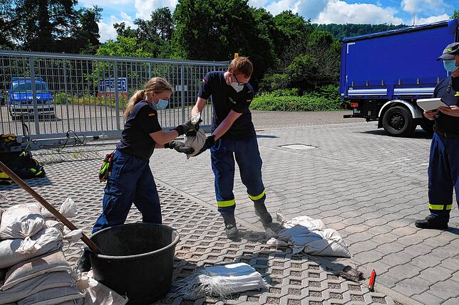 Gabriela Bürgi und Ben Gedlich haben hier die Aufgabe Sandsäcke für Flutkatastrophen zu füllen und zu stapeln.