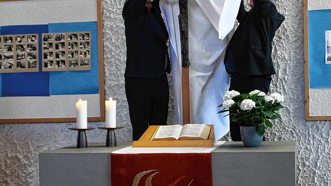 Das Kreuz am Altar wird abgedeckt – die Kirche wird weltlich. Bild: Rolf Reißmann