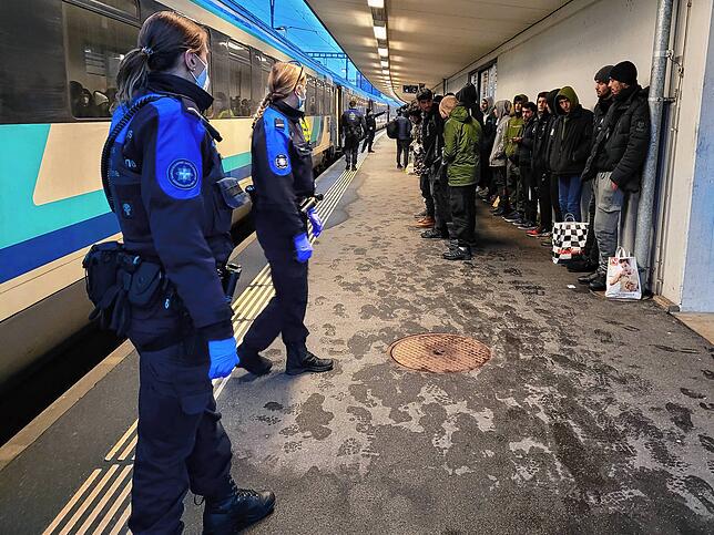 Die illegalen Migranten müssen sich am Gleis aufstellen und werden durchgezählt.