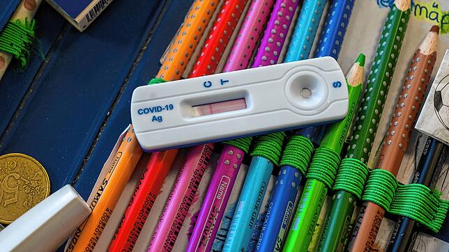 Ein Corona-Teststreifen liegt auf einem Mäppchen. Schulkinder müssen sich derzeit dreimal wöchentlich testen. Die Inzidenz bei den Fünf- ...