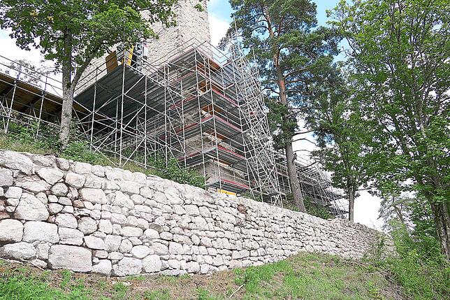 Die Steinfangmauer im Vordergrund und die dahinter liegende Burghofmauer (rechts eingerüstet) wurden nachträglich in die ...