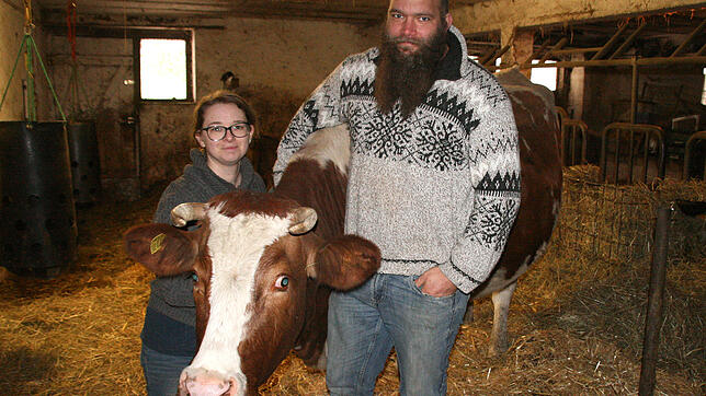 Bieten Tieren eine neue Heimat: Kathrin und Christian Schindler im Stall mit einer Kuh. Derzeit leben 65 Tiere unterschiedlicher Rassen ...